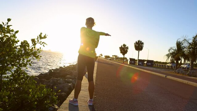 Sunrise woman healthy exercise outdoors Gulf of Mexico 
