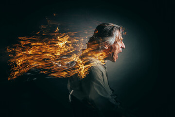 Portrait of a screaming man in anger with a fiery trail behind his head. - 619111146