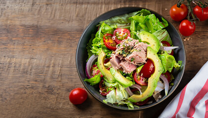 healthy food bowl with tuna fish salad with lettuce, cherry tomatoes, avocado and red onions. 