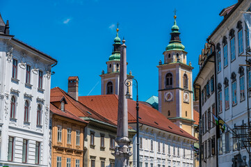 Fototapeta na wymiar A view of Baroque buildings beside the River Ljubljanica in Ljubljana, Slovenia in summertime