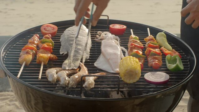 Barbeque with grilled chicken, vegetables and fish on the grill