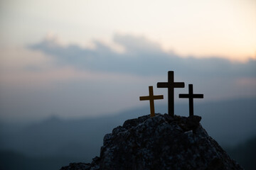 The three holy crosses of Jesus Christ shining through the red sky and clouds and bright rays...