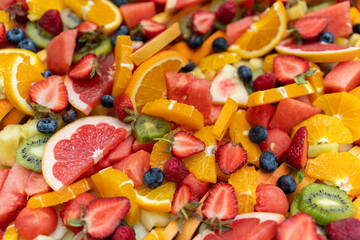 Background of healthy fresh summer fruit salad in vibrant colors