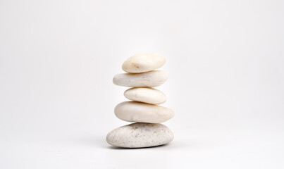 Fototapeta na wymiar pile of white stones isolated on white background. Stones pyramid. Life balance and harmony concept.vertical.