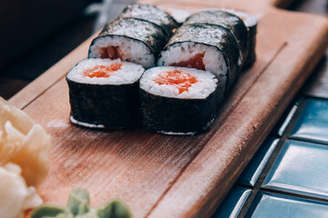 Sushi on a wooden table in a restaurant.