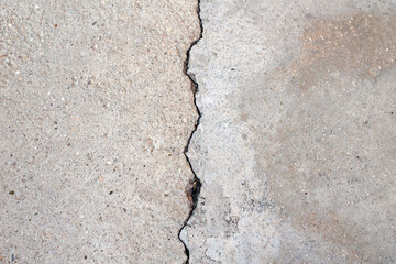 Broken asphalt roads, caused by earthquake. A large crack in concrete.