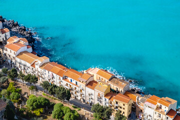 Aerial view of street in Cefalu old town and turquoise sea water on Sicily island, Italy. Medieval...