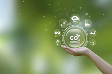 Hand holding bubbles with Co2 neutral icon, Reduce CO2 emissions to limit climate change and global warming. carbon dioxide CO2 molecules. Sustainable development and business based on renewable