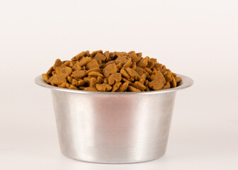 Dry Cat or Dog Food on a Metal Bowl, no cat, isolated, white background, front view, focused