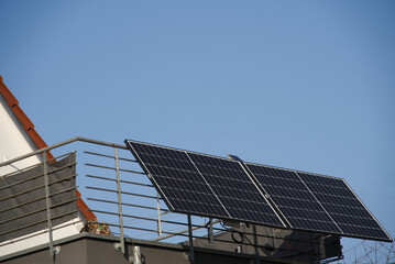 Balcony power plant on a terrace railing. Sunshine and cloudless sky