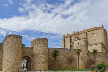Fototapeta na wymiar defensive walls of the city of ronda ,almocabar gate and church of the espiritu santo in ronda ,malaga,spain