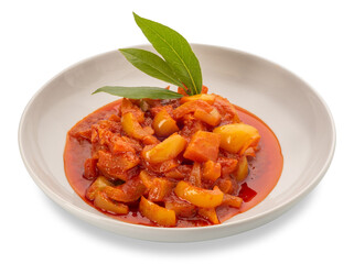 Pepper stew with potatoes in tomato sauce with green bay leaves in white dish