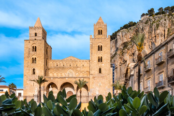 Fototapeta na wymiar Norman cathedral with two towers in Cefalu, medieval town on Sicily island, Italy. Historic church in old town under La Rocca cliff. Popular tourist attraction in Province of Palermo