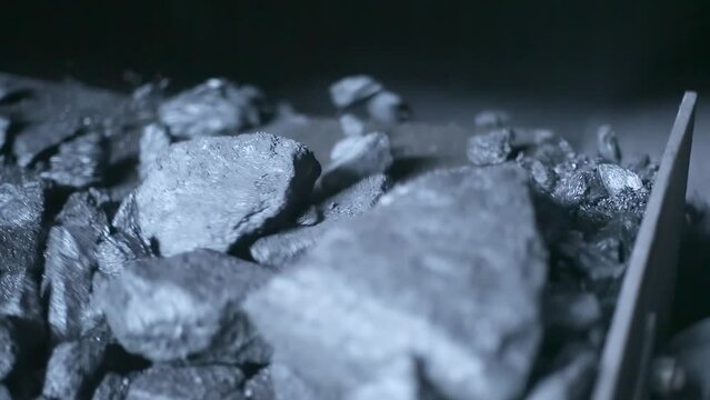 Closeup of charcoal or bituminous coal moving downward into the furnace chamber