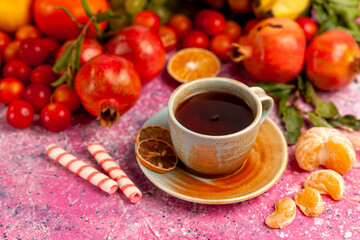front view fresh fruit composition with cup of tea on light pink background fresh mellow color ripe vitamine fruit tree