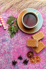 top view cup of tea with candies and waffles on pink desk sugar bake biscuit sweet color