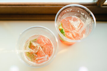 Overhead view of cold summer drinks with strawberries and mint leaves