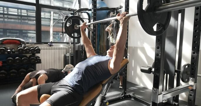 Man doing bench press in a gym