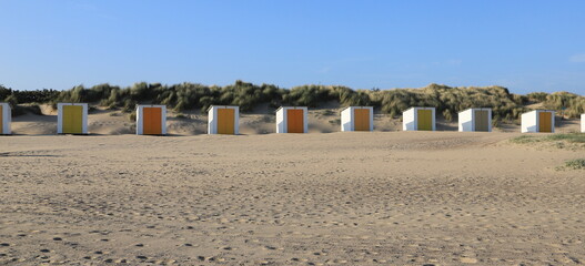 small colorful beach huts at the north sea in the netherlands