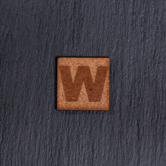 Capital Letter In Square Wooden Tiles - Black Stone Background