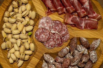 Plate with pistachios, prosciutto, sausages and dry sausage