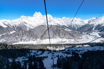 Beautiful nature lanscape with Caucasus mountain and pine forest covered with snow in winter. Cable...
