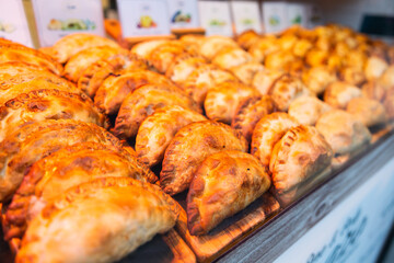 freshly baked empanadas with different fillings for sale