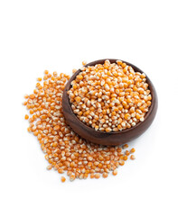 Dried corn kernels in wooden bowl isolated on white