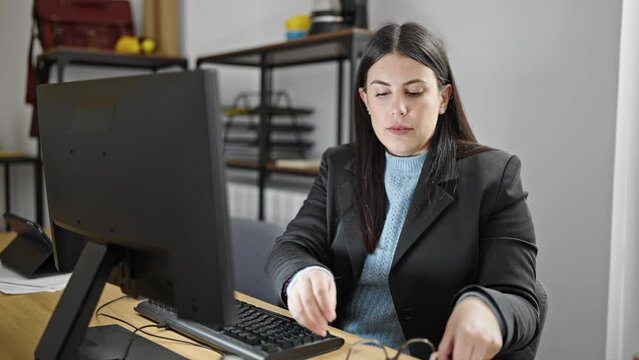 Young hispanic woman business woman with problem to see screen at office