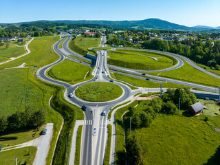New highway junction in Poland on national road no 7, E77, called Zakopianka.  Overpass crossroad with traffic circles, slip ramps and viaducts near Rabka. Aerial view