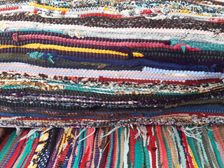 Background of various handmade cotton arabic fabrics. Chill out. Colorful wool Bedouin blankets. Arabic decoration and culture.