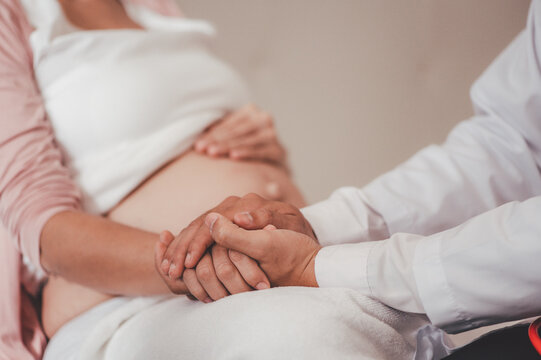 Love of family, motherhood, parenthood and expectation concepts. Asian woman and husband encourage his girlfriend about to give birth the baby.
