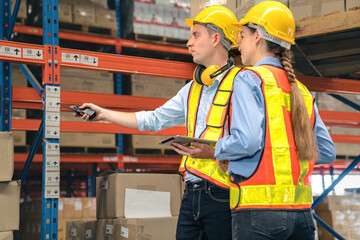 Caucasian man, woman warehouse supervisor discuss and use tablet check package with forklift driver...