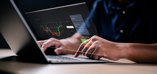 Concept Planning and strategy, Stock market, Hands of businessman working at home. Technical price graph and indicator, Red and green candlestick chart and stock trading computer screen.