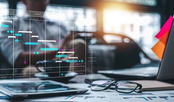 Concept marketing plan, Project management schedule plan diagram, sales, marketing. Businessman is schedule a work plan each month on laptop computer at workplace.