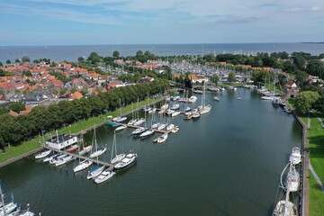 Fototapeta na wymiar Drone overview photo of Medemblik, the Netherlands. This is a small town on the Ijsselmeer with many opportunities for water sports enthusiasts. There are also many old historic buildings
