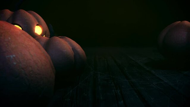 Spooky halloween background with pumpkin face and spider web on ground looped