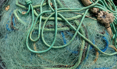 macro of fisherman's nets rolled up at the port