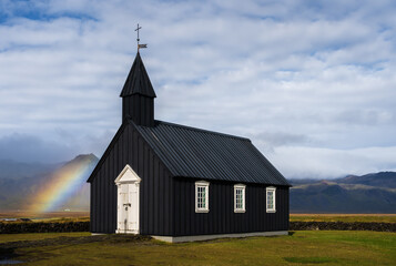 Fototapeta na wymiar Rainbow at Budir black church in Snaefellsnes peninsula, Iceland
