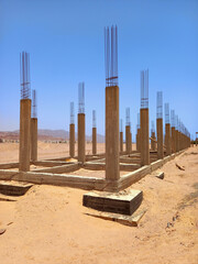 Concrete pillars in the desert under blue sky. Building foundations in Dahab. Building structure....