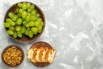 top view fresh green grapes mellow and delicious with cakes on light-white desk fruit fresh mellow...