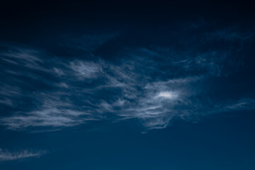 Clouds in the night sky illuminated by the light of the moon