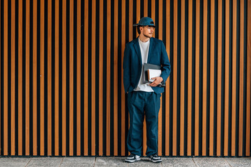 student with books in the street