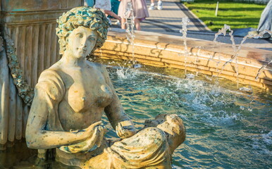 Fototapeta na wymiar Sculpture decorating an old park fountain