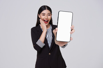 Happy smiling Asian business woman showing blank screen smart phone isolated on white studio...