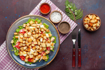 top view tasty caesar salad with little rusks and seasonings on dark background salad food meal...