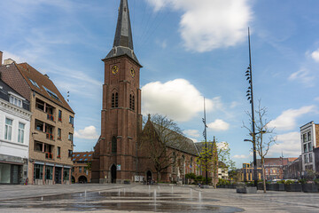 Marketplace of the city Moeskroen, Mouscron België.  Blue sky and church.