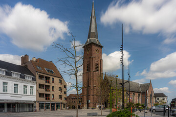Marketplace of the city Moeskroen, Mouscron België.  Blue sky and church.