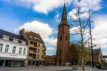 Marketplace of the city Moeskroen, Mouscron België.  Blue sky and church.