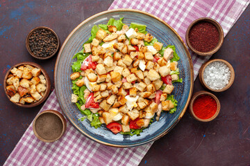 top view tasty caesar salad with little rusks and seasonings on the dark desk salad food meal lunch vegetables